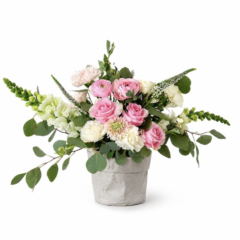Pink Pearl flower arrangement with pink roses, ranunculus, white carnations and green bells of Ireland in a gray pot
