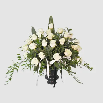 A Full Life funeral flower arrangement - White roses in black urn vase Vancouver