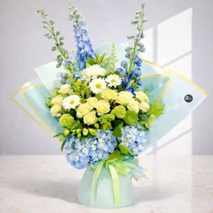 Sky Blooms Bouquet - Blue delphiniums, blue hydrangeas, and yellow roses in light blue wrapping Vancouver