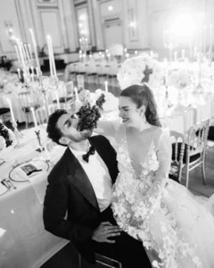 Bride and groom at wedding reception with bride feeding groom grapes