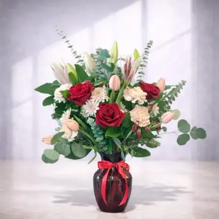 Red Punch floral arrangement - Red roses, pink lilies, and pink tulips in red glass vase Vancouver