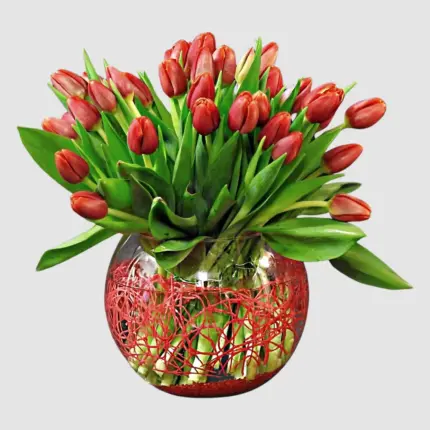 Tulips Arrangement - Red tulips in clear glass bowl vase with decorative red mesh Vancouver
