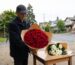 Man holding a large red rose bouquet next to a white chrysanthemum bouquet for delivery in North Vancouver